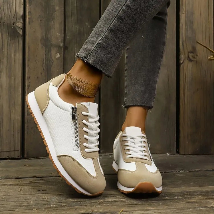 Women's grey flat-heeled shoes with artificial PU upper and rubber sole on a plain background.