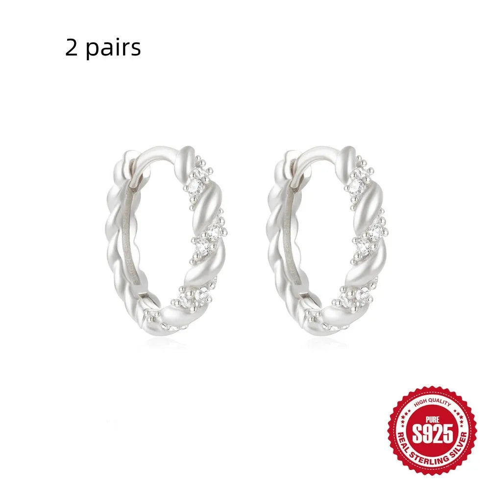 Small round geometric sterling silver stud earrings in gold and silver electroplated finishes.