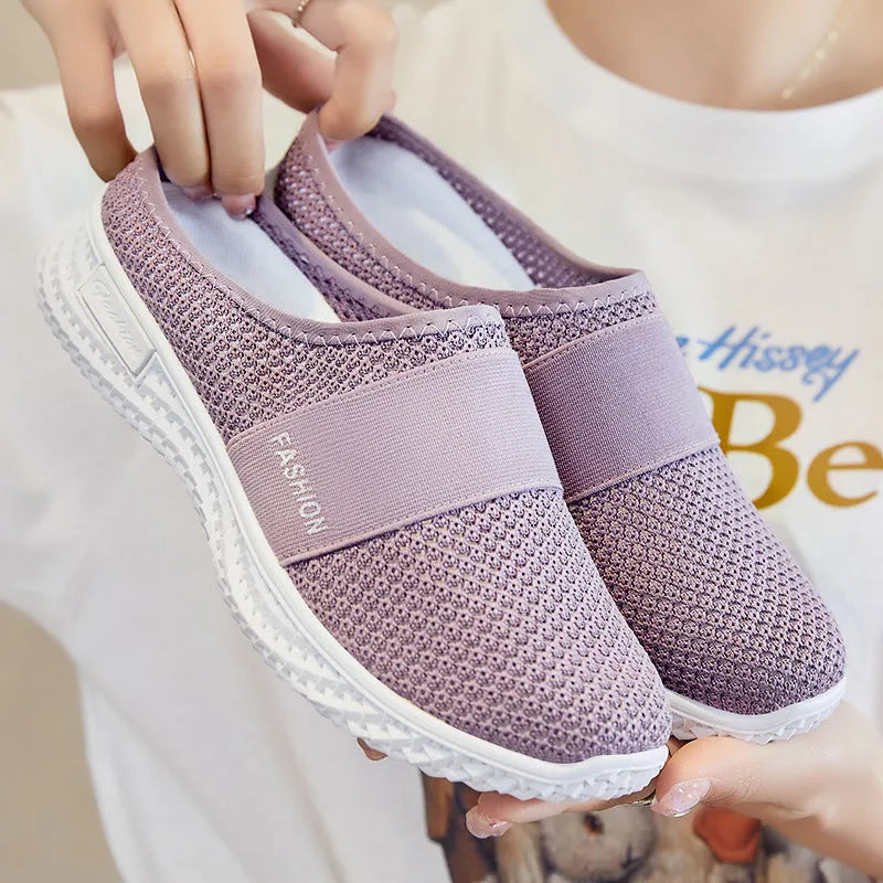 Women's black mesh casual flat shoe with round toe and hollow-out design on a neutral background.