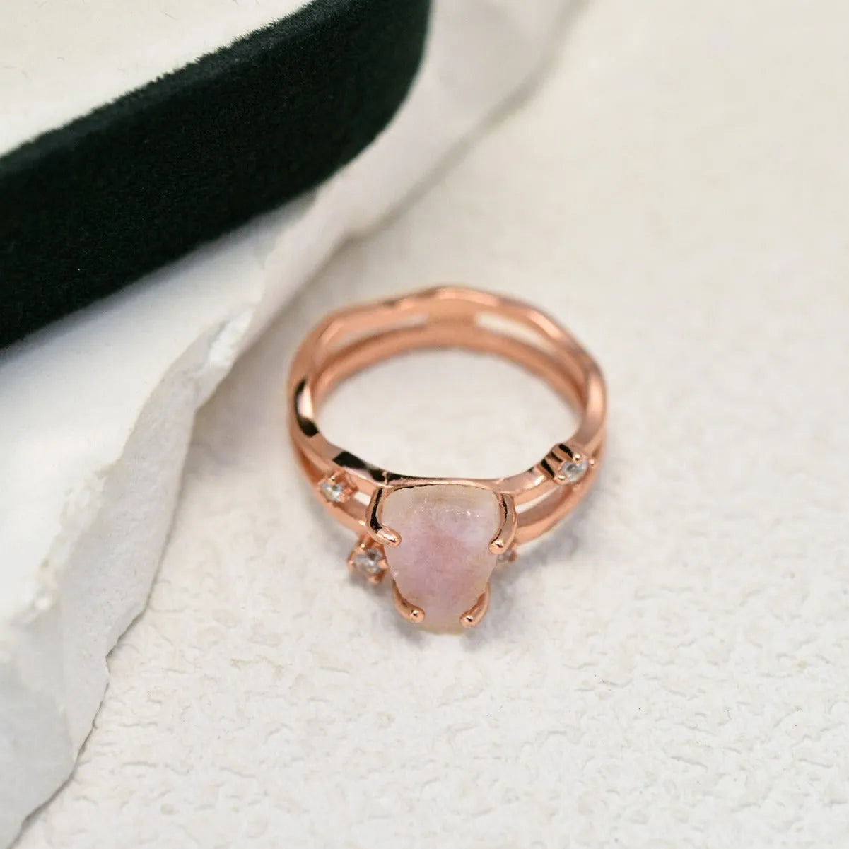 S925 silver geometric ring with irregular triangle shape and central moonstone on a model's hand.
