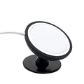 Black magnetic car phone holder mounted on vehicle air vent with smartphone attached
