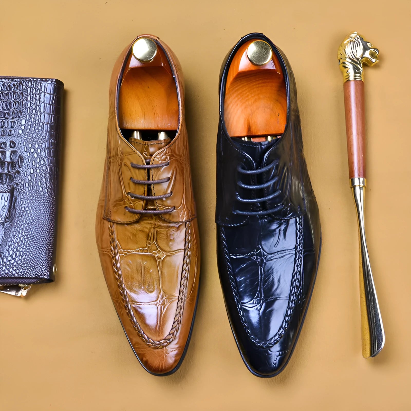 Men's black leather shoes with alligator print texture and a silver horse bit buckle.