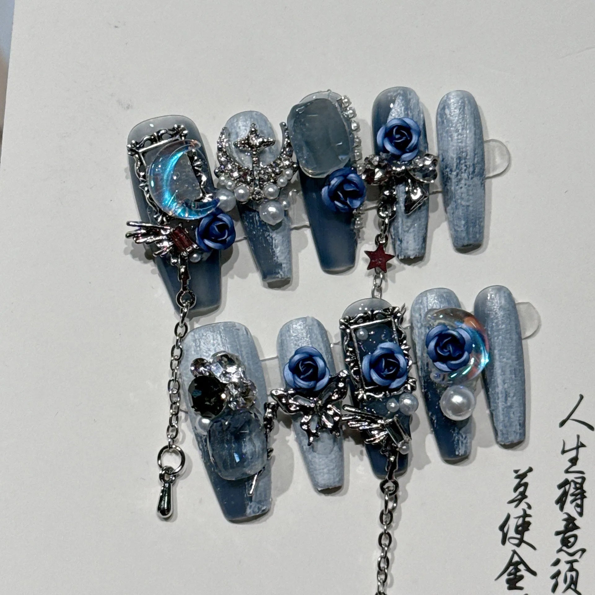 Blue artificial nails with rose flower pattern for evening manicure in four sizes