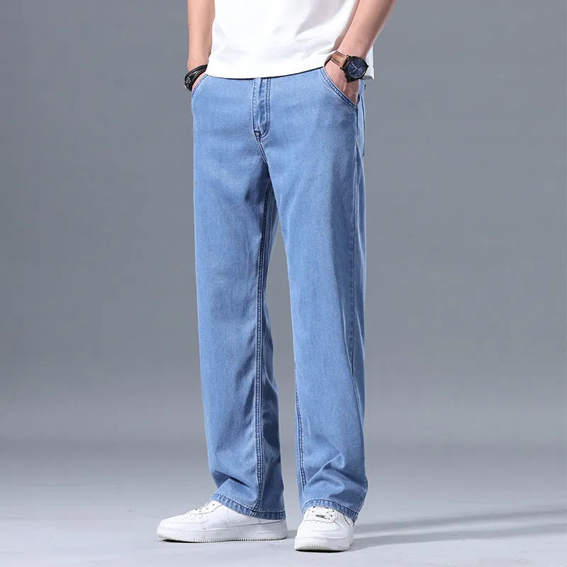 Men's loose straight-leg jeans in a lyocell-blend denim, shown in light blue colour with a zipper fly.