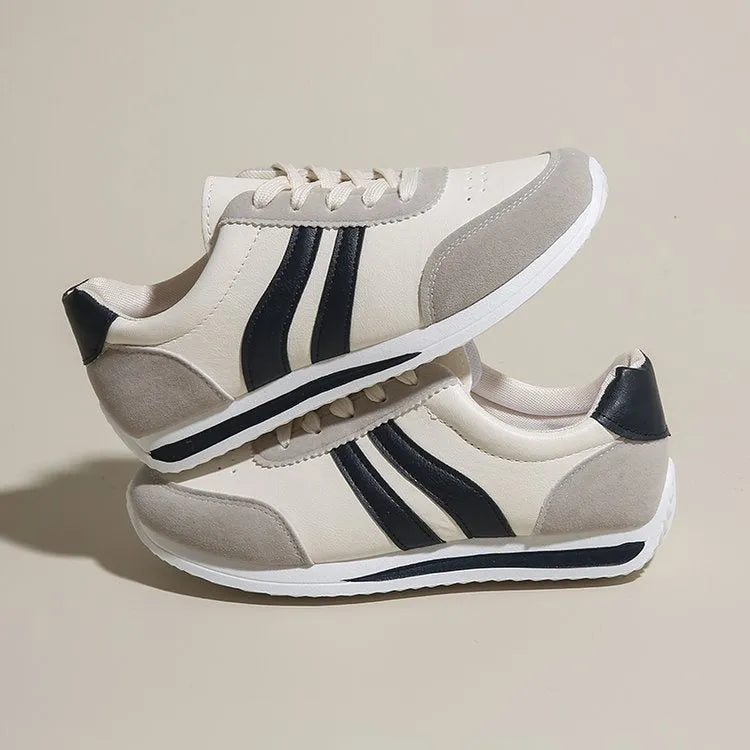 Low-top blue and red lace-up sneakers with mesh upper and rubber sole on a white background
