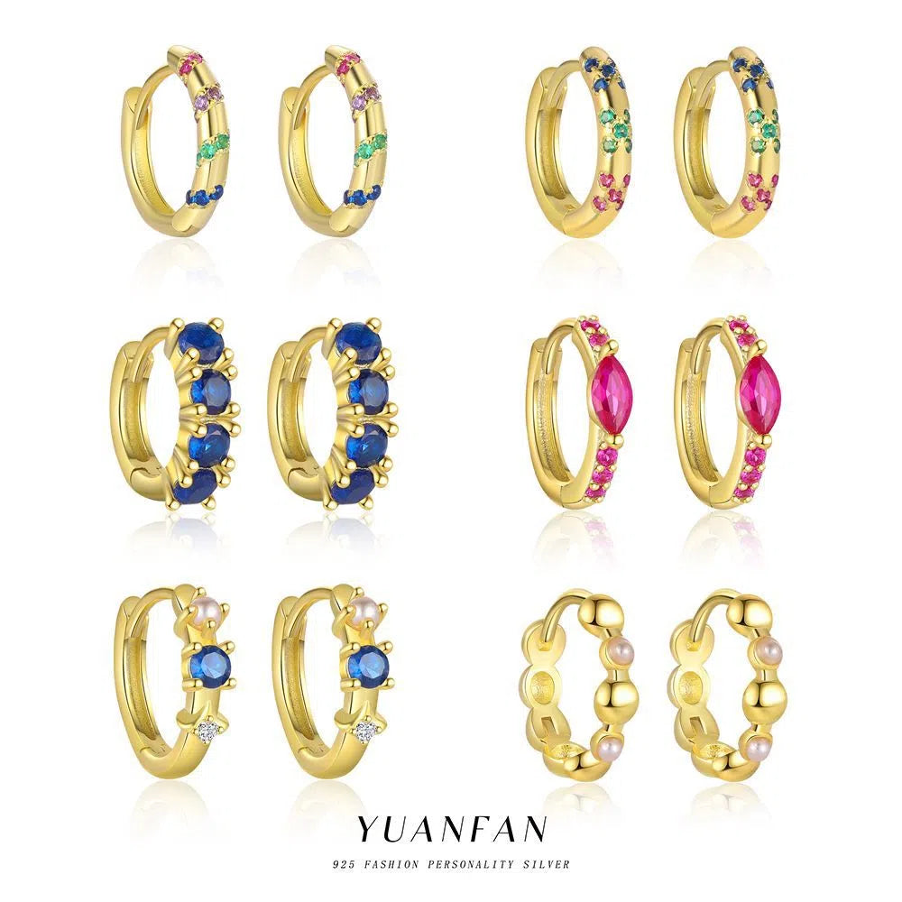 S925 sterling silver geometric earrings with yellow gold finish and inlaid zircon stone on white background