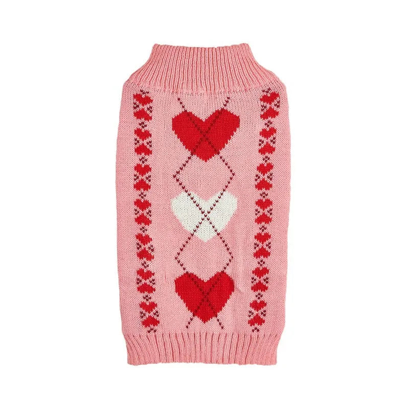 Dog wearing red love heart patterned sweater in acrylic knit fabric