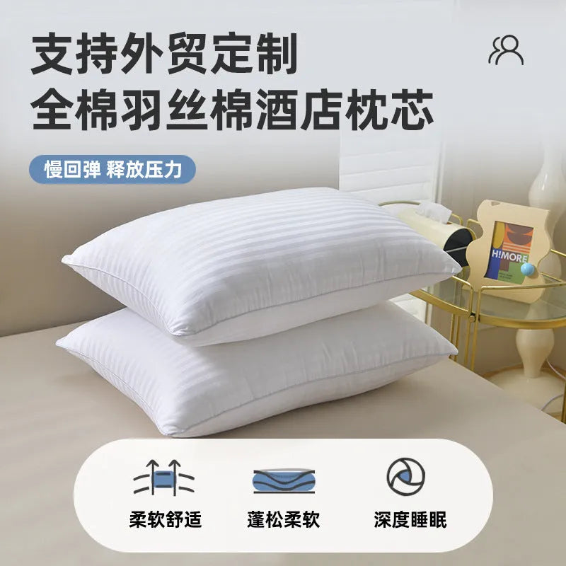 White cotton satin stripe pillow with feather and cotton filler on a bed.