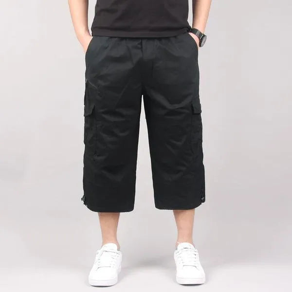 Men's loose fit cotton cropped pants in army green colour, shown on a hanger.