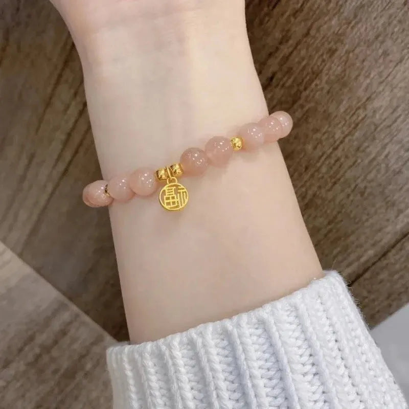 Chinese style glass bracelet with bamboo joint details in a red Lvzhu Duobao design.