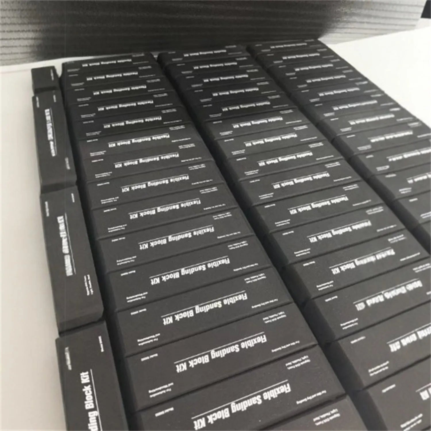 Set of seven black frosted metal EVA display blocks arranged together.