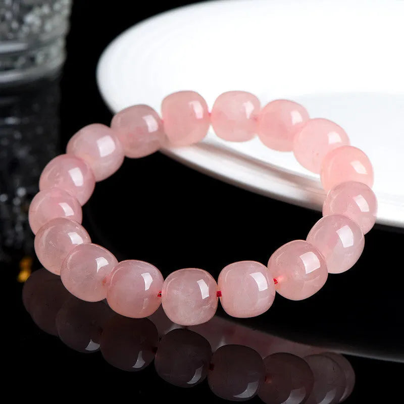 Pink crystal barrel bead bracelet with geometric design and polished finish