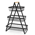 Detachable double-layer iron fruit basket with wooden handle in black on a kitchen tabletop