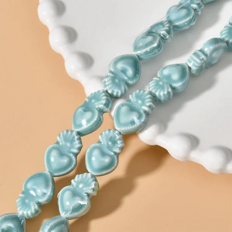 Ceramic heart torch beads in various colours for jewellery making, approximately 10mm by 15mm with straight hole