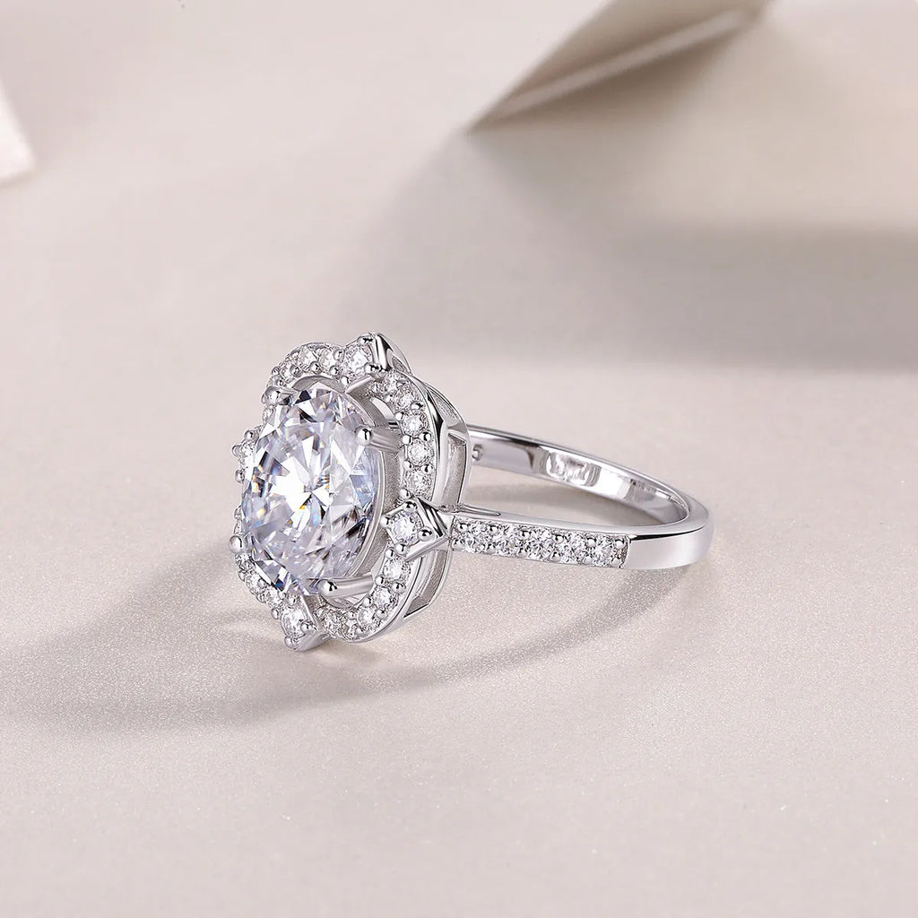Camellia egg-shaped moissanite wedding ring set with S925 silver and platinum plating, showing centre stone and band