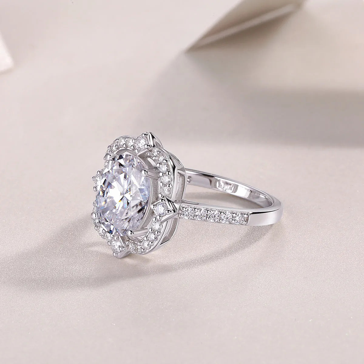 Camellia egg-shaped moissanite wedding ring set with S925 silver and platinum plating, showing centre stone and band