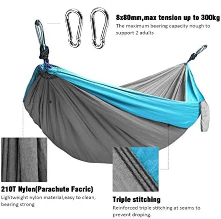 Blue ripstop nylon outdoor hammock with suspension ropes hung between trees