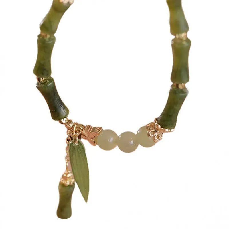 Chinese style glass bracelet with bamboo joint details in a red Lvzhu Duobao design.