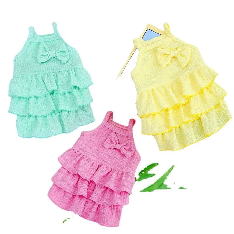 Small dog wearing a layered princess dress in a candy skirt style, available in rose red, yellow, or green.