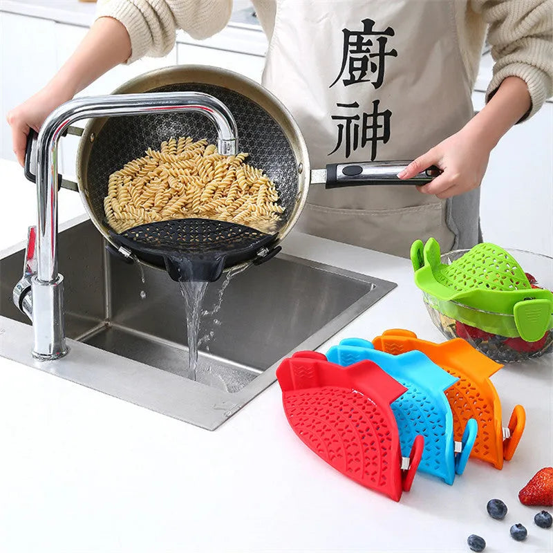 Silicone pot side drain stopper in black attached to saucepan rim with leak-proof edge