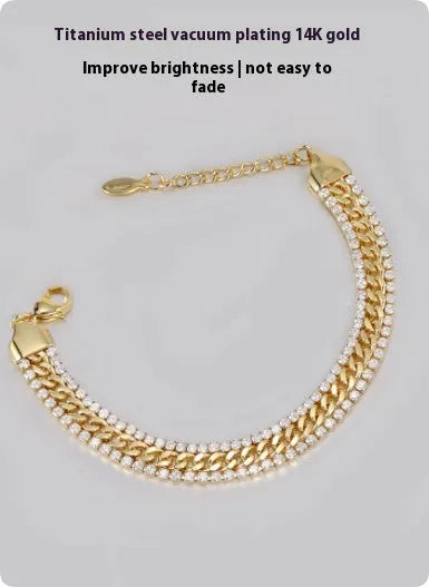 Gold coloured hip hop style tennis bracelet with stone inlay on a wrist.
