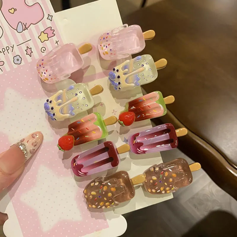 Close-up of a handmade resin hair barrette with a cute cartoon ice cream design in a choice of colours.
