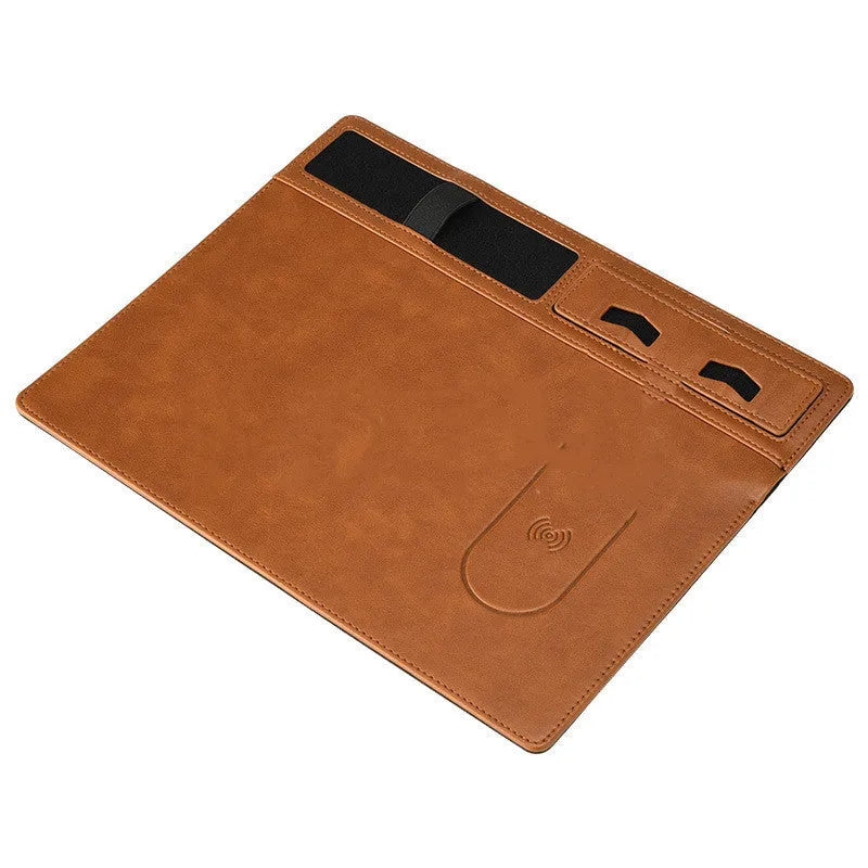 Pink wireless charging mouse pad with phone on charging area and mouse on PU leather surface