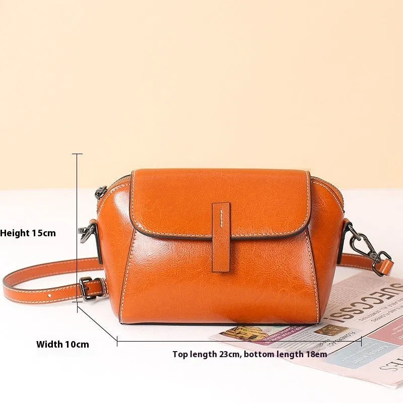 Women's brown oil wax leather messenger bag with cross-body strap and multiple internal compartments