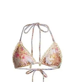 Creamy-white floral women's bikini set with matching skirt on beach