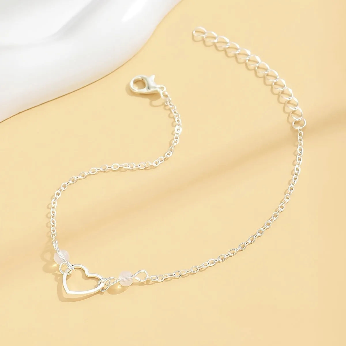 Women's anklet with heart-shaped pendant on adjustable alloy chain