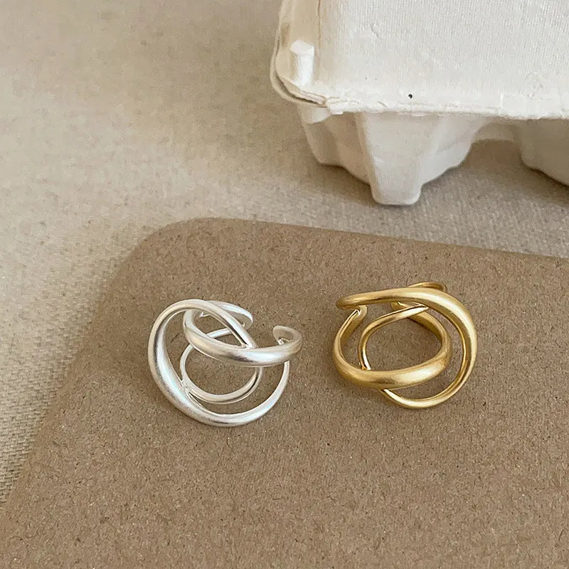 Geometric open ring with three-dimensional interlaced design in matte metal finish