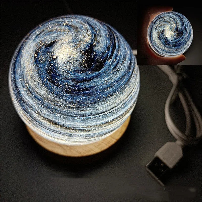 Planet night light with USB cable and base in modern simple design showing spherical shape