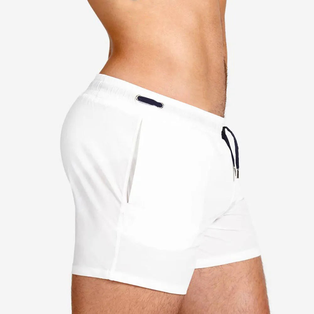 Men's solid colour mesh lining polyester sports shorts for swimming and fitness.
