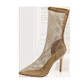 Gold women's stiletto sandals with mesh upper and pointed toe on a rubber sole.