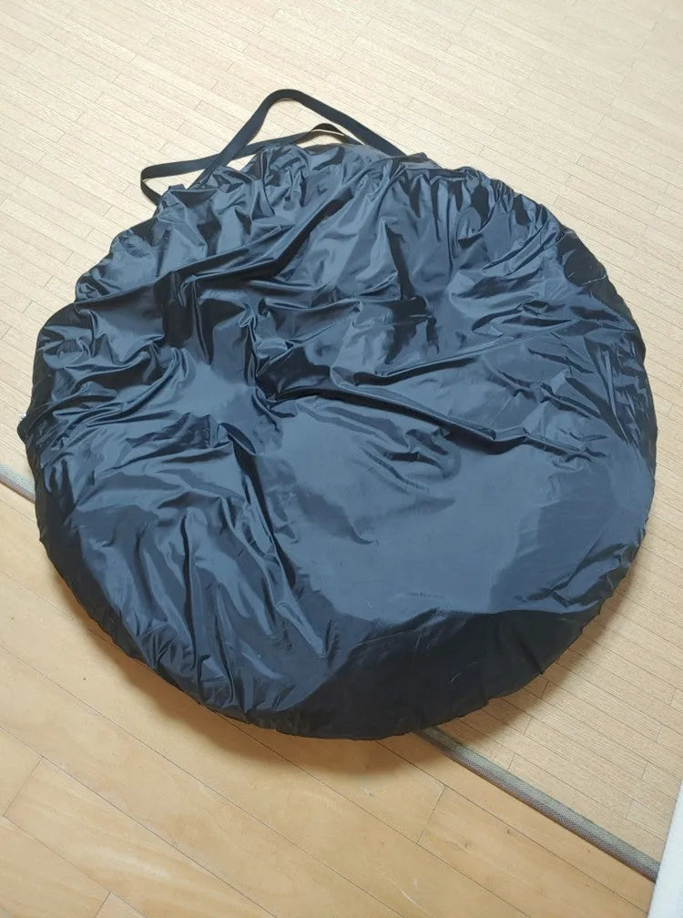 Black pop-up tailgate tent unfolded next to a car, showing its cubic 200cm shape and quick-throw design.