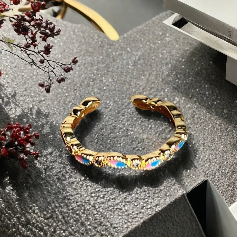 Adjustable gourd vintage ring with oil dripping finish in New Chinese style showing bow-shaped elements and zircon details