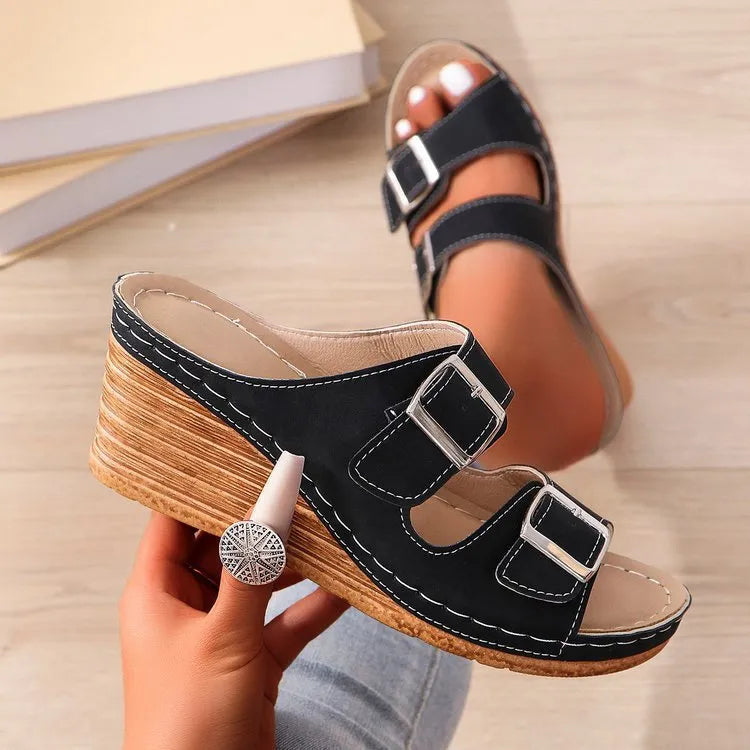 Women's creamy-white beach slippers with an outer wedge belt buckle fastening.