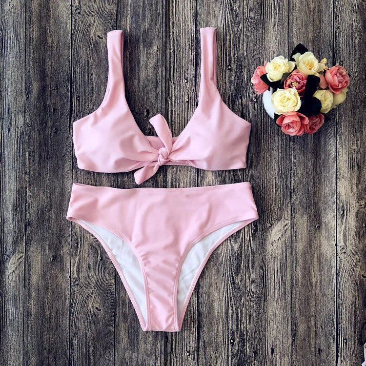 Women's solid colour bikini set showing bra top and matching panties in polyester fabric