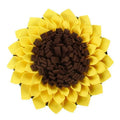 Yellow sunflower-shaped dog snuffle mat with fleece texture and a hanging rope buckle.