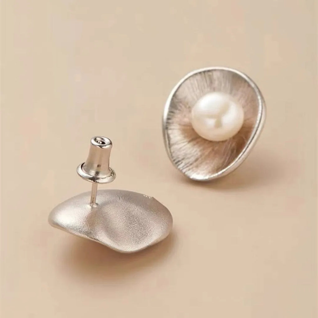 Sterling silver earrings with geometric design and cultured pearl accents on needle back fittings