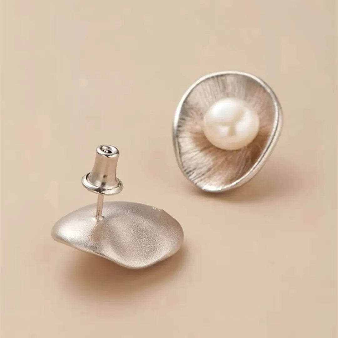 Sterling silver earrings with geometric design and cultured pearl accents on needle back fittings