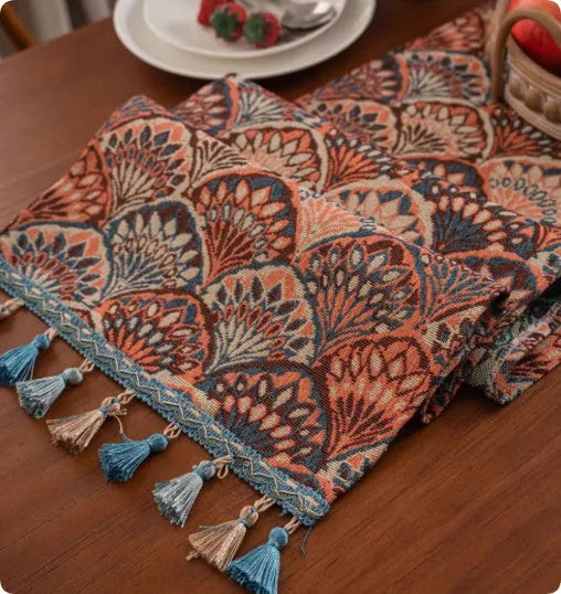 Country European retro style table flag with long handwoven tassels draped over a wooden sideboard.