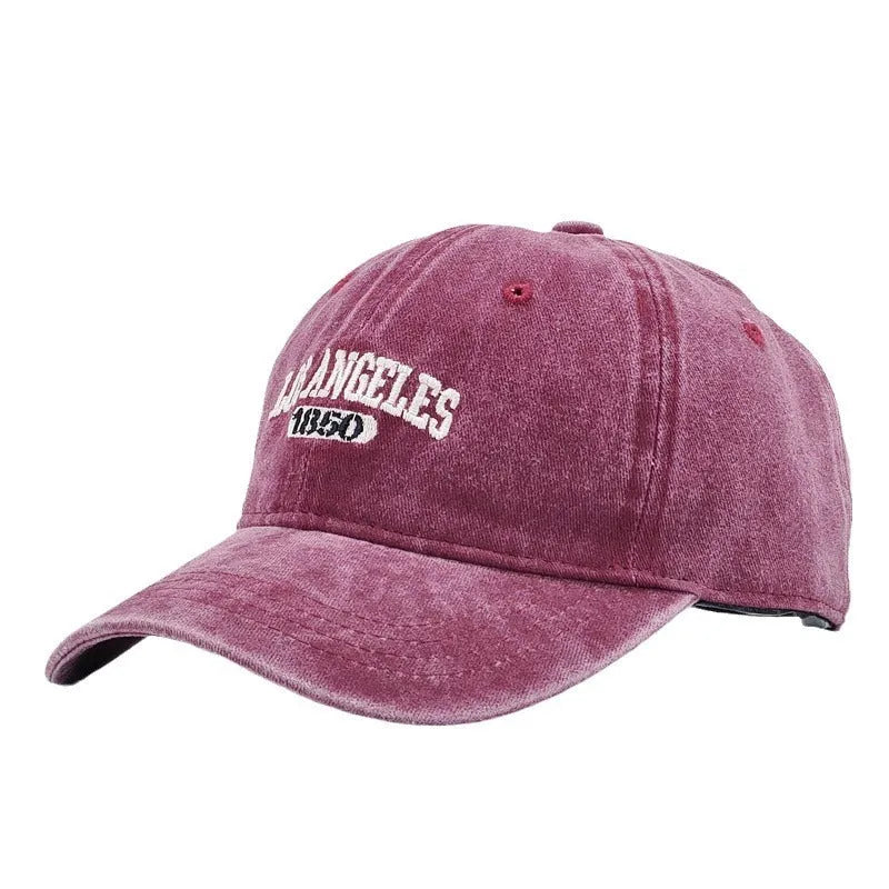 Retro-style personalised baseball cap with distressed letter embroidery on an adjustable strap, shown in beige colour.