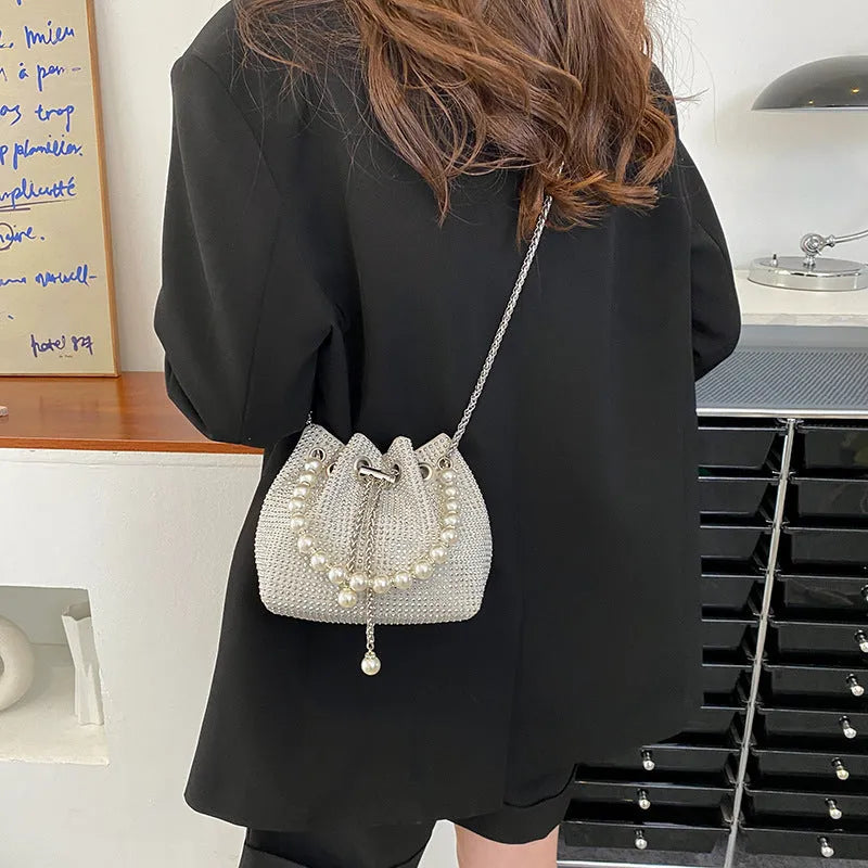 Light diamond pattern shoulder bag with western style chain crossbody and bucket shape design
