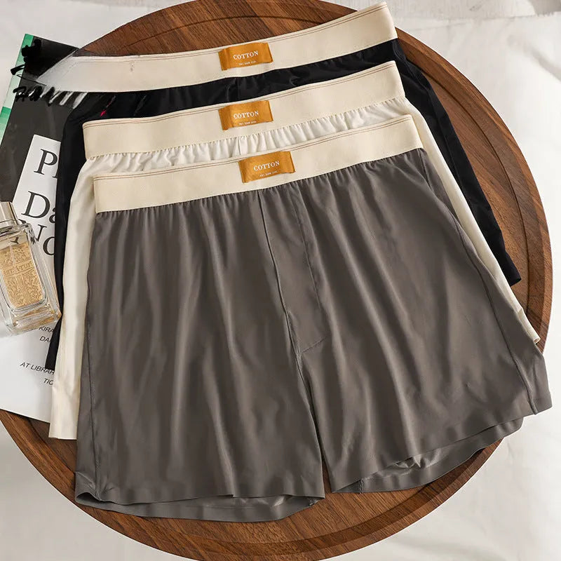 Men's solid colour loose Ice Silk underwear briefs on a neutral background