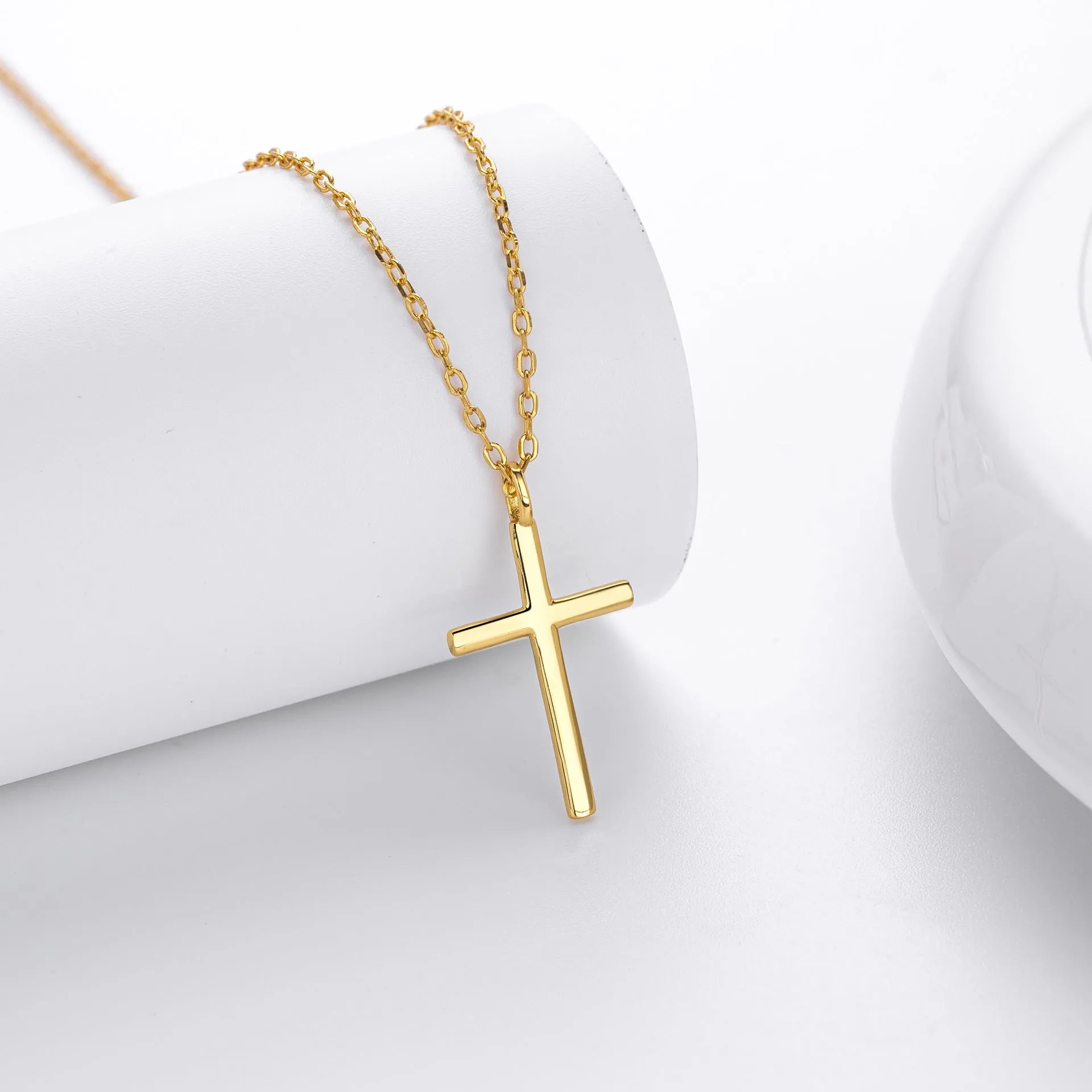 Simple sterling silver cross pendant necklace with glossy finish on adjustable O-link chain
