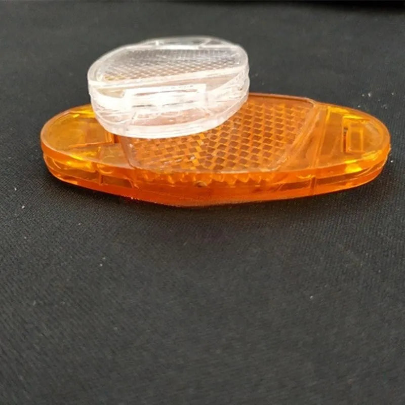 White and yellow plastic bicycle wheel spoke reflectors showing dimensions