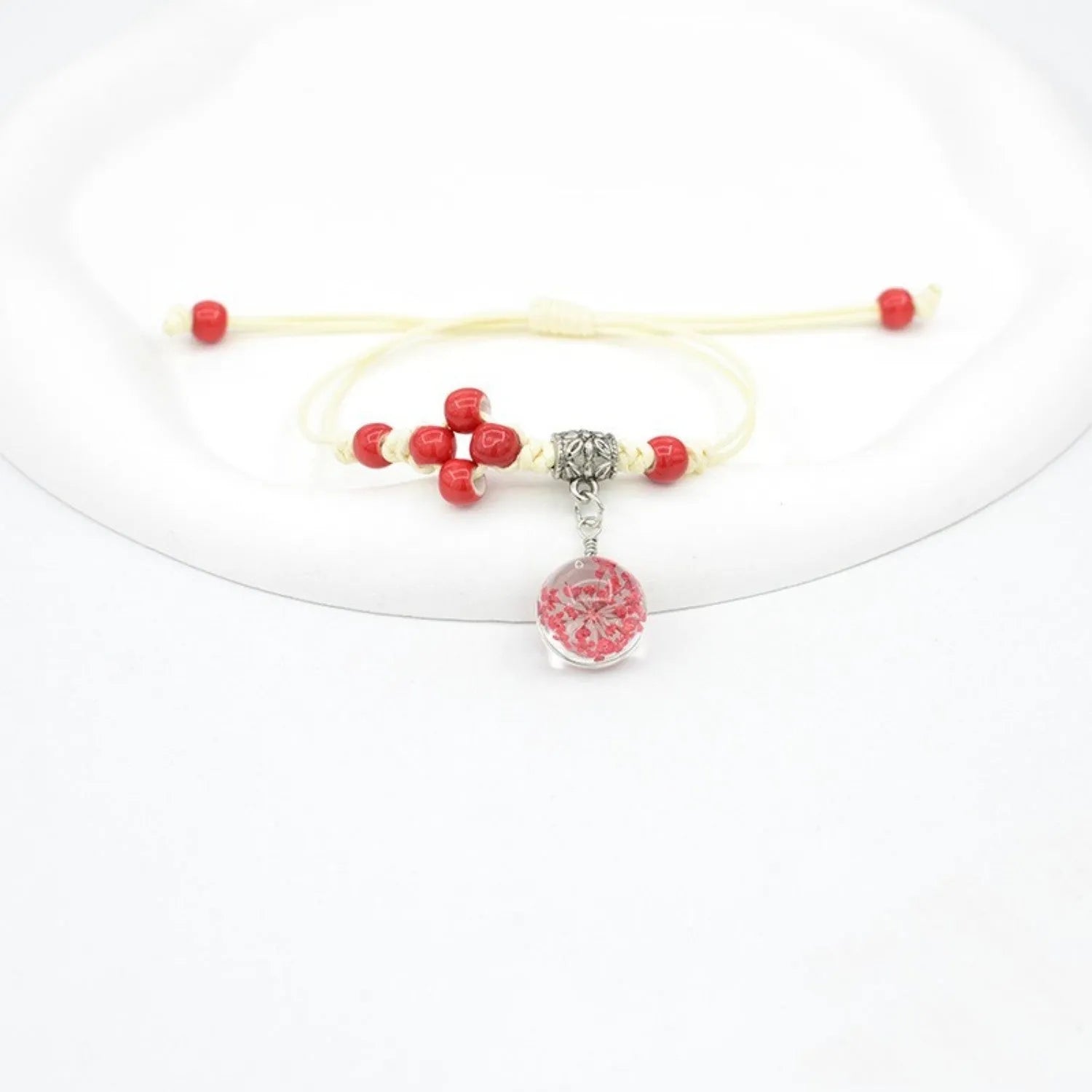 Hand-woven glass bracelet with 1.4cm beads containing real dried flowers in various colours