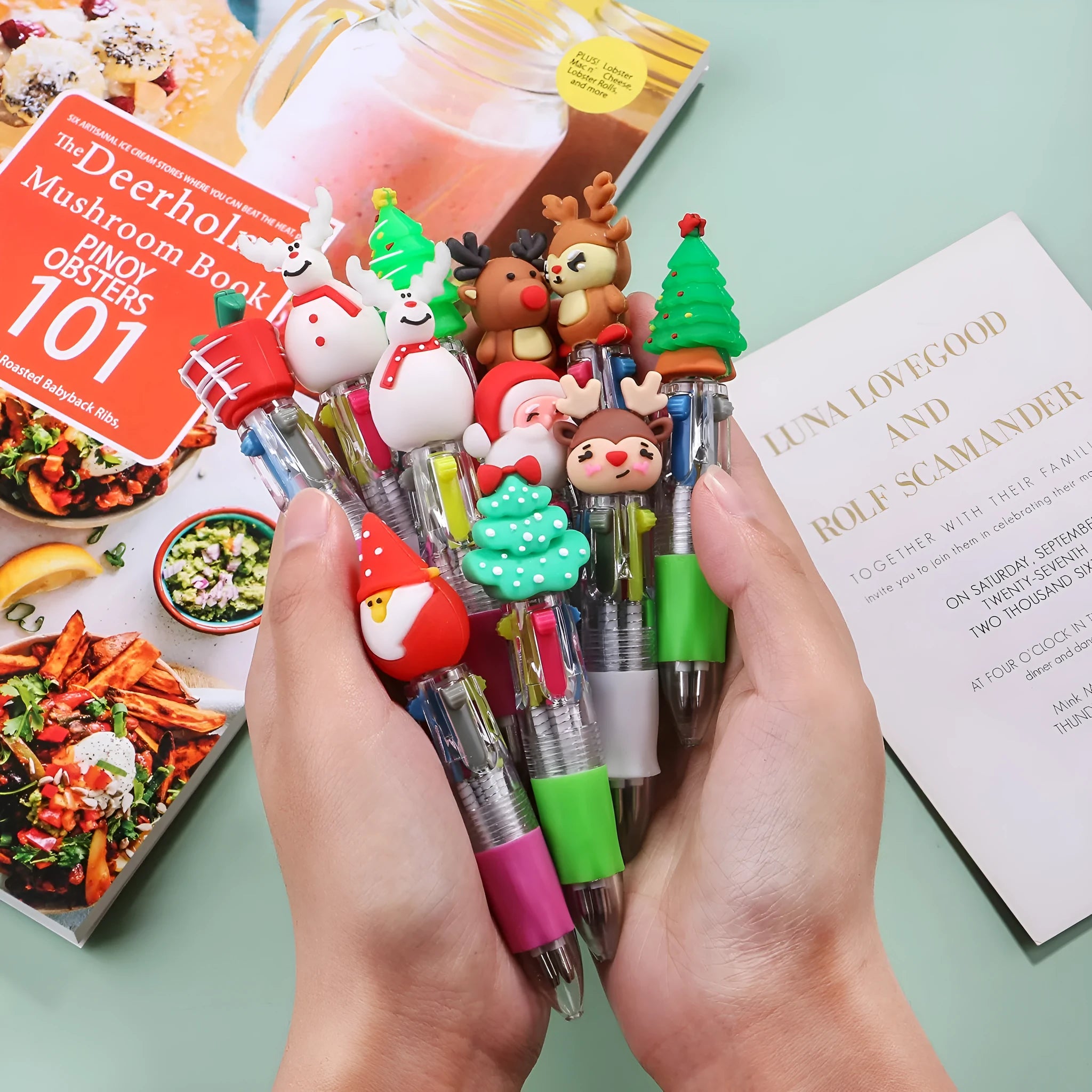 Compact 11cm Christmas-themed press-action ballpoint pen with festive designs.
