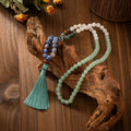 Vintage bohemian long necklace with geometric stone beads and tassel, shown with a matching shorter bracelet.